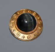 A late Victorian 15ct yellow metal and 'cat's eye' cabochon set circular brooch, 29mm