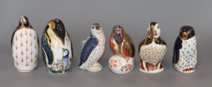 Six Royal Crown Derby puffins and penguin paperweights