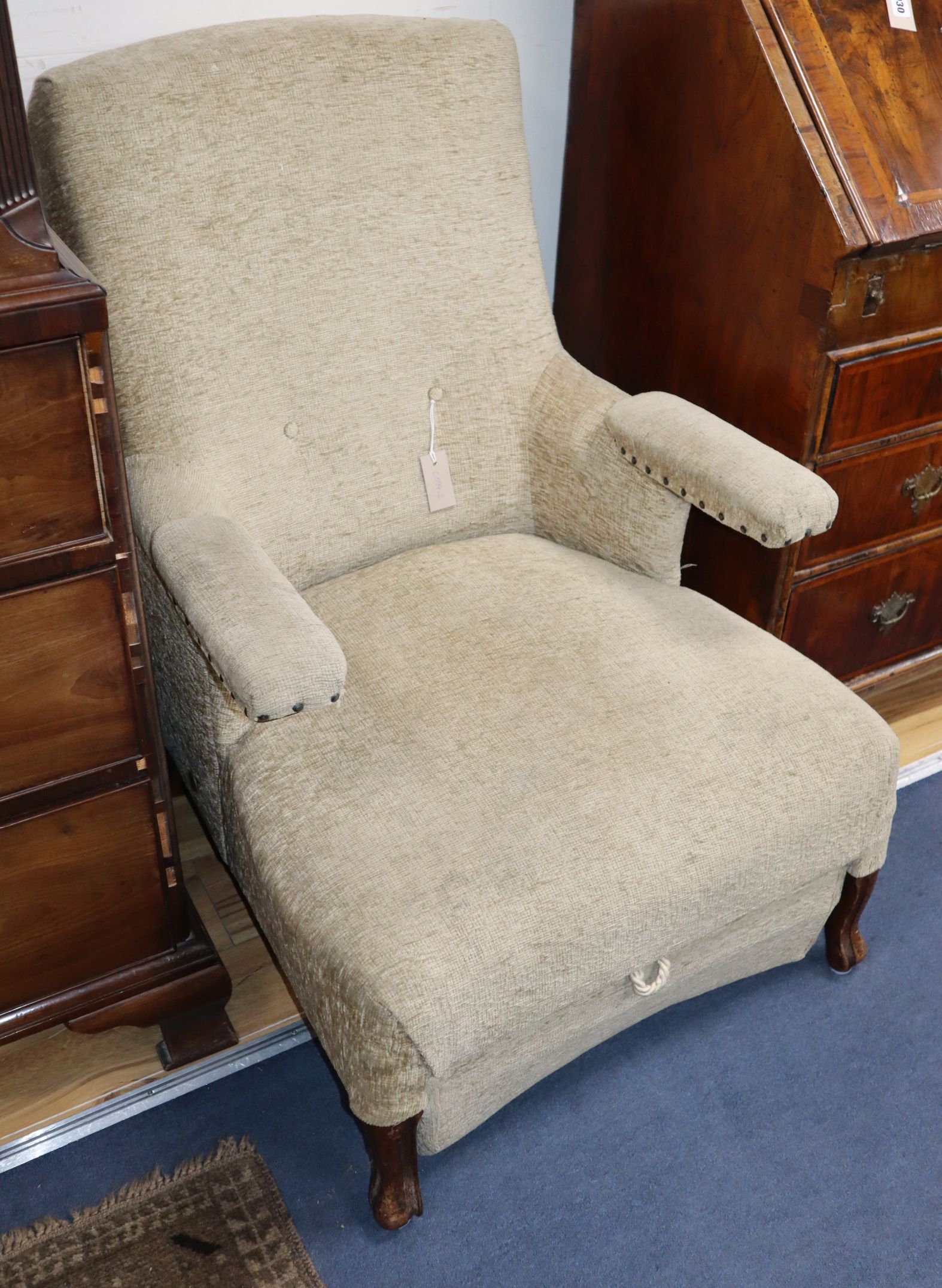 A 19th century French metamorphic armchair, with folding armrest