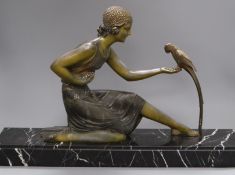 An Art Deco spelter figure of a girl with a bird, signed D.H. Chiparus base length 60cm