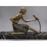 An Art Deco spelter figure of a girl with a bird, signed D.H. Chiparus base length 60cm