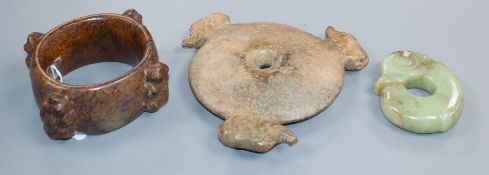 Three Chinese archaistic jade or hardstone zoomorphic carvings, including a bi disc, a ring and a