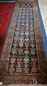 A North West Persian black ground runner 310 x 90cm