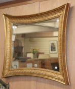 A shaped rectangular gilt frame wall mirror W.97cm