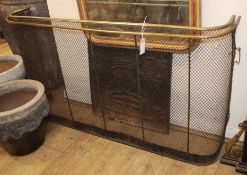 A 17th century style cast iron fire back and a Victorian brass tipped, wire mesh nursery guard (2)
