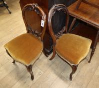 A pair of Victorian carved mahogany balloon back dining chairs