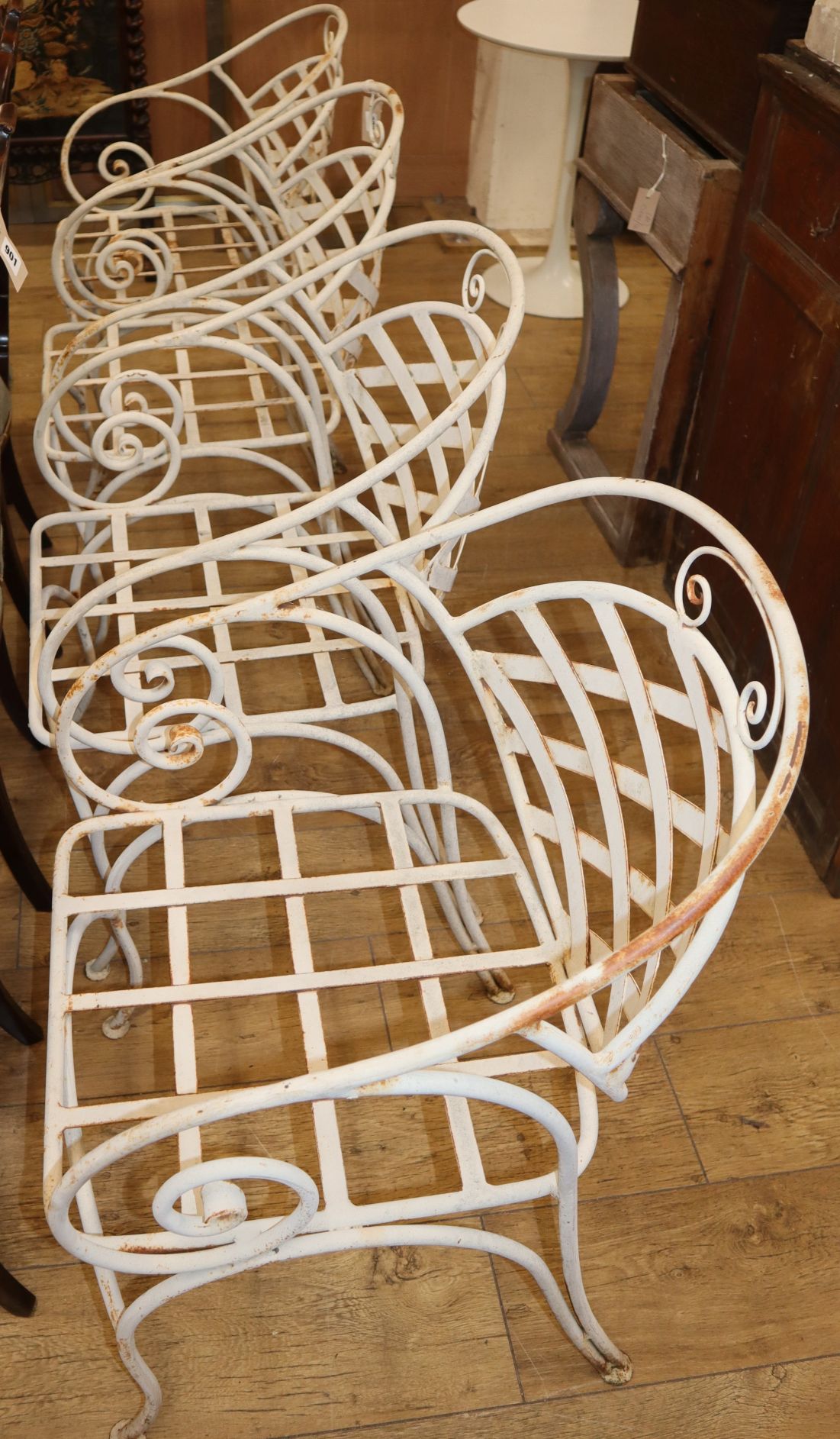A set of four painted wrought iron garden chairs