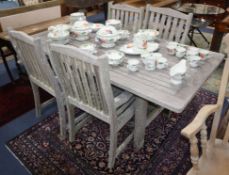 A teak garden table and four armchairs W.183cm