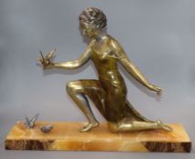 An Art Deco spelter figure of a girl with three birds, on marble base, signed U. Cipriani base