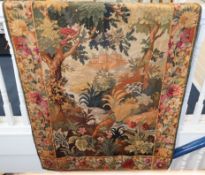 A 19th century wool tapestry of a castle in a woodland