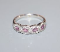 A modern 18ct white gold, pink sapphire and diamond quadruple cluster ring, size R.