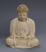 A Japanese ivory okimono of Buddha, Meiji period 12cm high