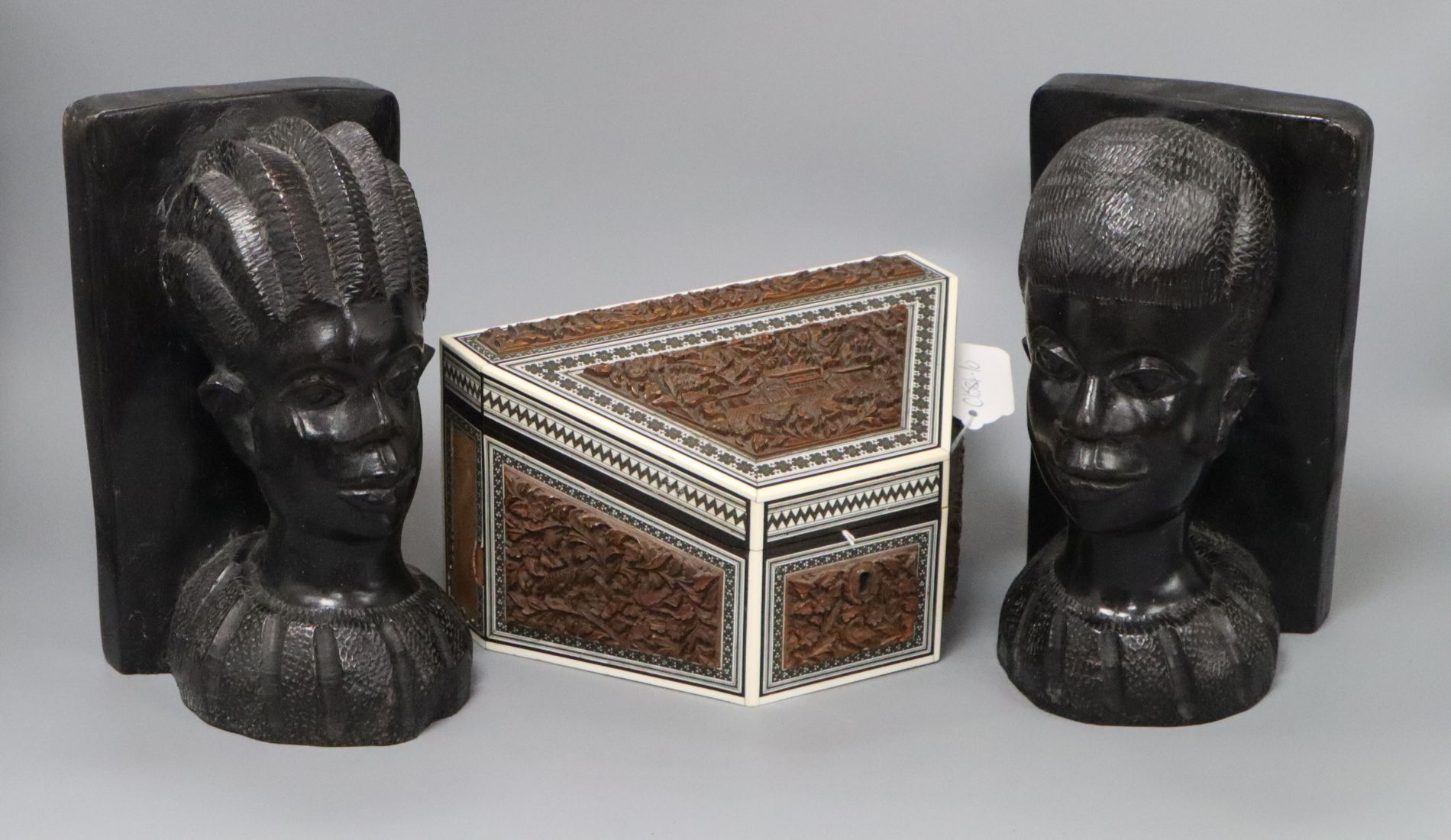 A pair of African carved bookends and an Anglo Indian carved wood box