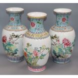 A pair of Chinese famille rose vases and another similar (3) Height 36cm