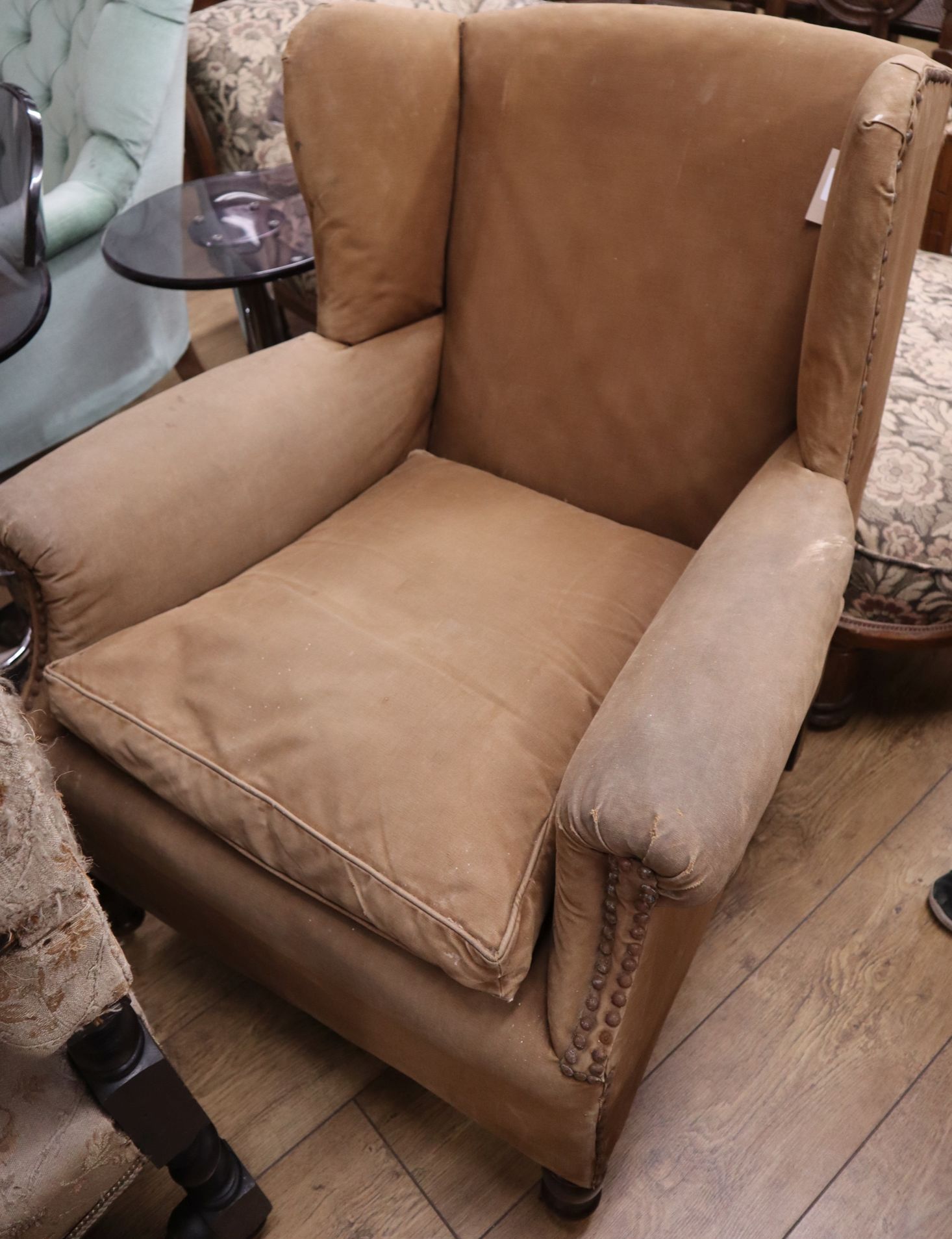 A late Victorian studded upholstered wing armchair