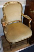 A giltwood open armchair and another armchair