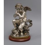 A silver and gilded French bronze of a seated Putti height 30cm