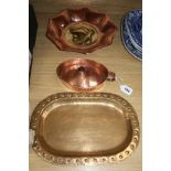 An Arts & Crafts copper candle holder, a copper and brass dish and a hammered brass dish