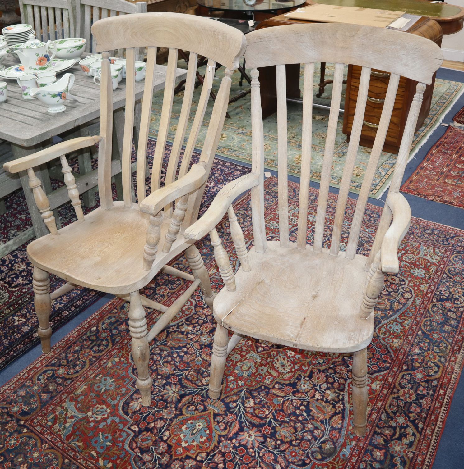 Two Victorian bleached elm and ash lathe back elbow chairs (one cut down)