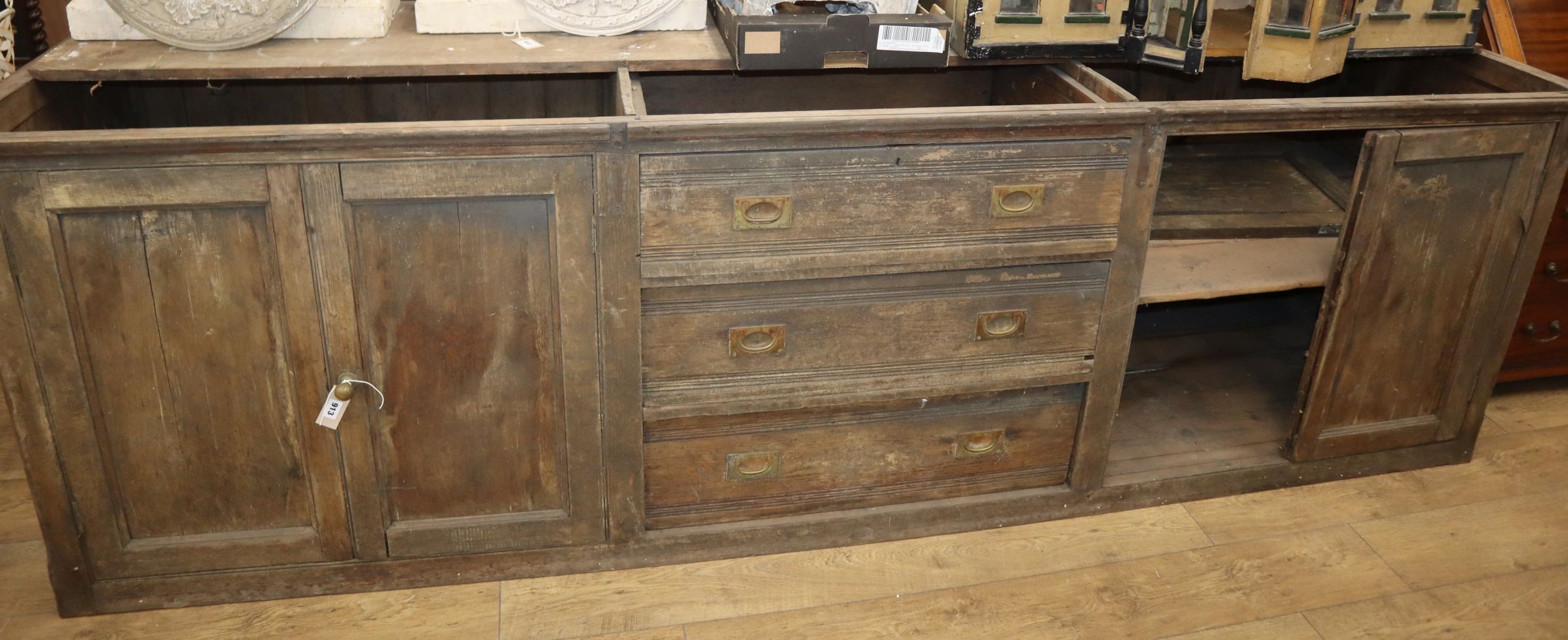 A large Victorian pine counter, lacks one top section Length 295cm