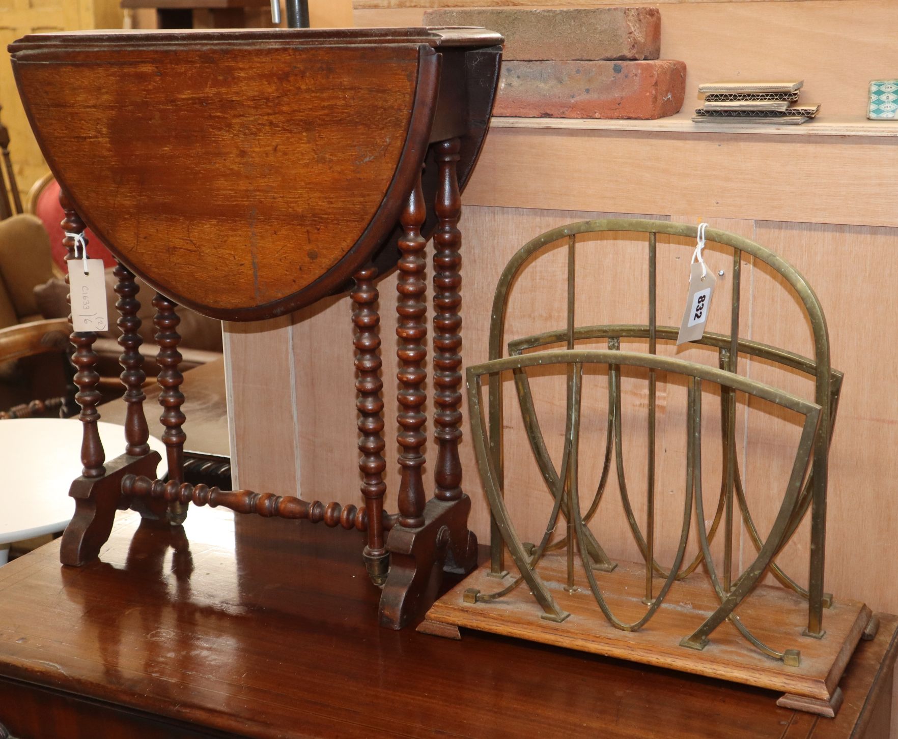 An oak and brass two division paper rack and a small Victorian Sutherland table