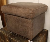 A brown leather footstool