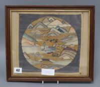 A Chinese kesi woven roundel, in gilt and polychrome thread of a figure in a mountainous landscape