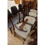 A set of four late Victorian salon chairs with pierced splats and floral tapestry seats