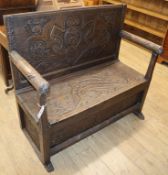 An 18th century style carved settle W.110cm