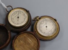 Two pocket barometers in leather cases