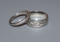 Two white metal wedding bands stamped "Plat".