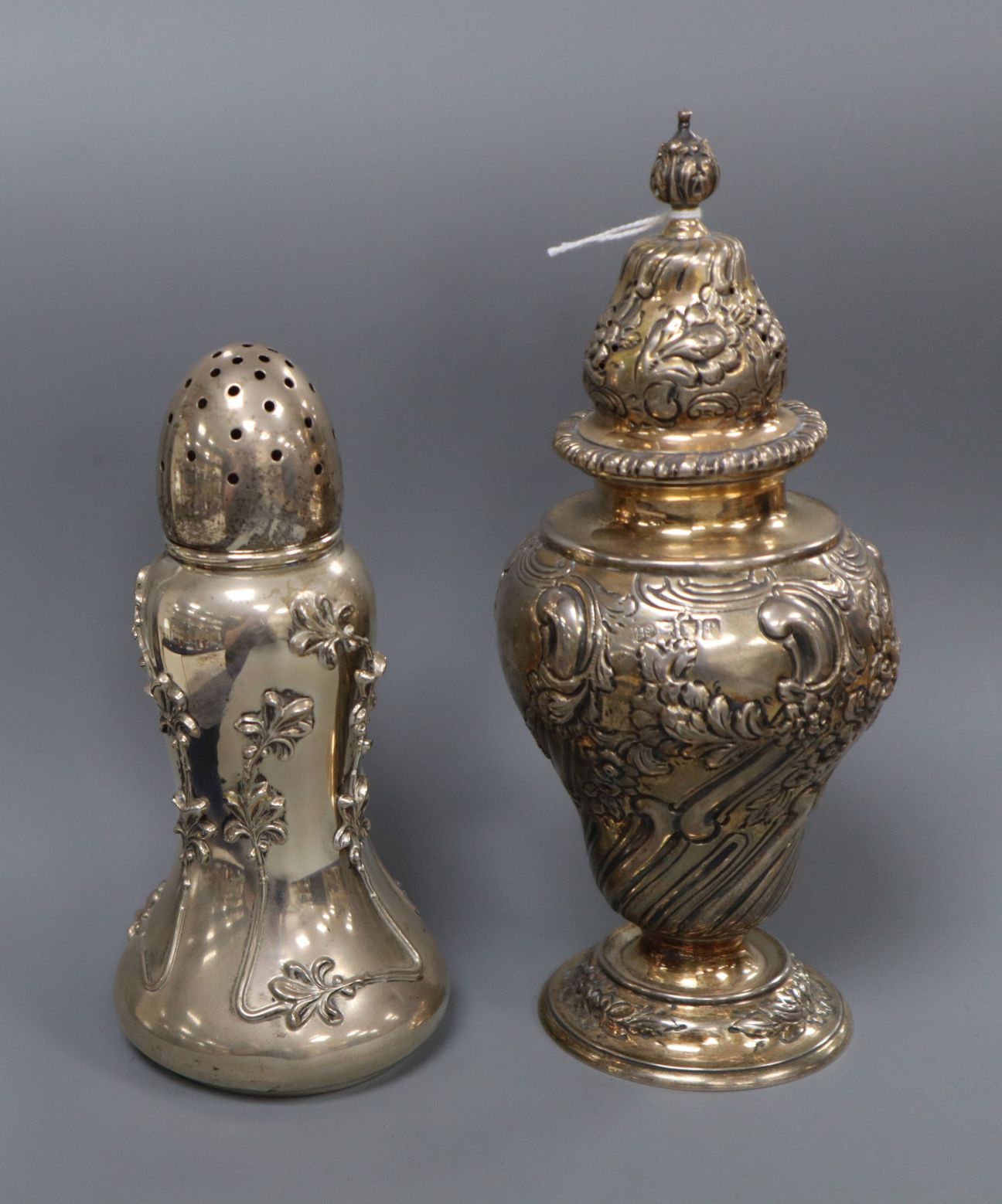 An Edwardian repousse silver sugar caster by Goldsmiths & Silversmiths Co Ltd, London, 1901 and a