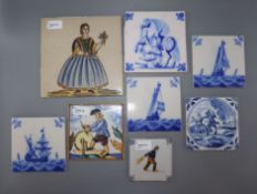 A collection of ceramic wall tiles, including Dutch Delft and Delft-style blue and white and Casa