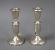 A pair of sterling candlesticks, loaded, 15.5cm