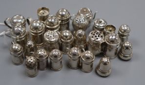 Twenty five assorted miniature Victorian and later silver peppers, including acorn, caster and churn
