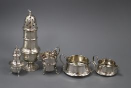 A 1930's silver sugar caster, two silver cream jugs, a sugar bowl and pepperette.