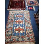 Four small Oriental rugs 152 x 103cm, 100 x 100cm, 77 x 67cm and 35 x 38cm