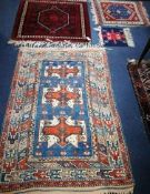 Four small Oriental rugs 152 x 103cm, 100 x 100cm, 77 x 67cm and 35 x 38cm