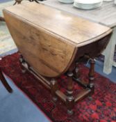 An oak oval topped gateleg dining table W108cm