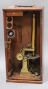 Baker. 244 High Holborn, London. A late 19th century brass monocular microscope, mahogany cased