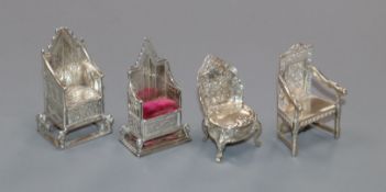 Four early 20th century miniature silver/white metal chairs, one a pincushion, one modelled as the