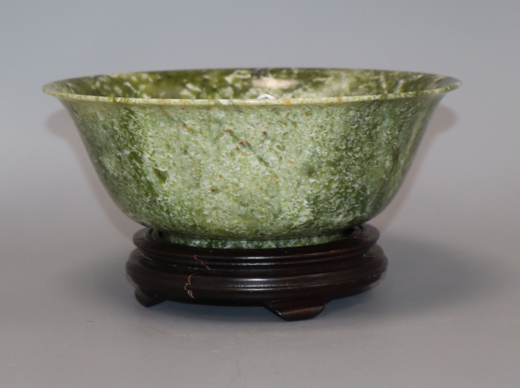 A modern Chinese spinach jade/bowenite bowl with hardwood stand, boxed Diameter 21cm