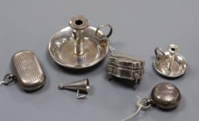 A silver combination stamp/sovereign case, another sovereign case, two miniature chambersticks and a