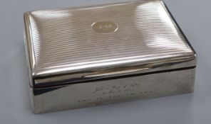 A Mappin & Webb engine-turned silver cigarette box, initialled and with presentation inscription