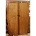 A panelled oak wardrobe and a matching night stand (reputed to be the work of John Skelton) Wardrobe