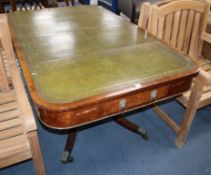 A Regency mahogany library table, with green gilt tooled leather inset top, on splayed legs Length