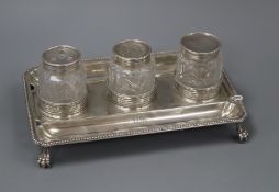 A George III silver rectangular inkstand, London, 1779, with three associated? mounted glass