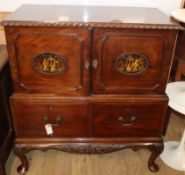 A carved side cabinet with ropetwist-moulded top over a pair of doors with oval Chinoiserie panels