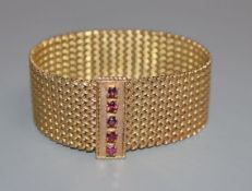 A 9ct gold milanese bracelet with ruby set clasp.