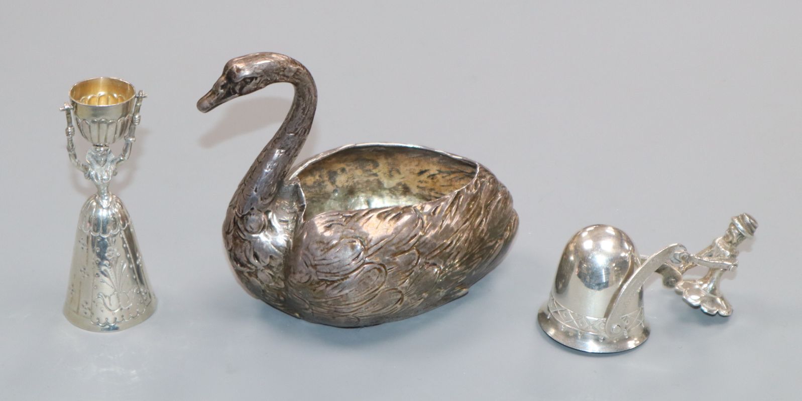 Two miniature silver marriage or wager cups (one articulated) and a large swan pin cushion (